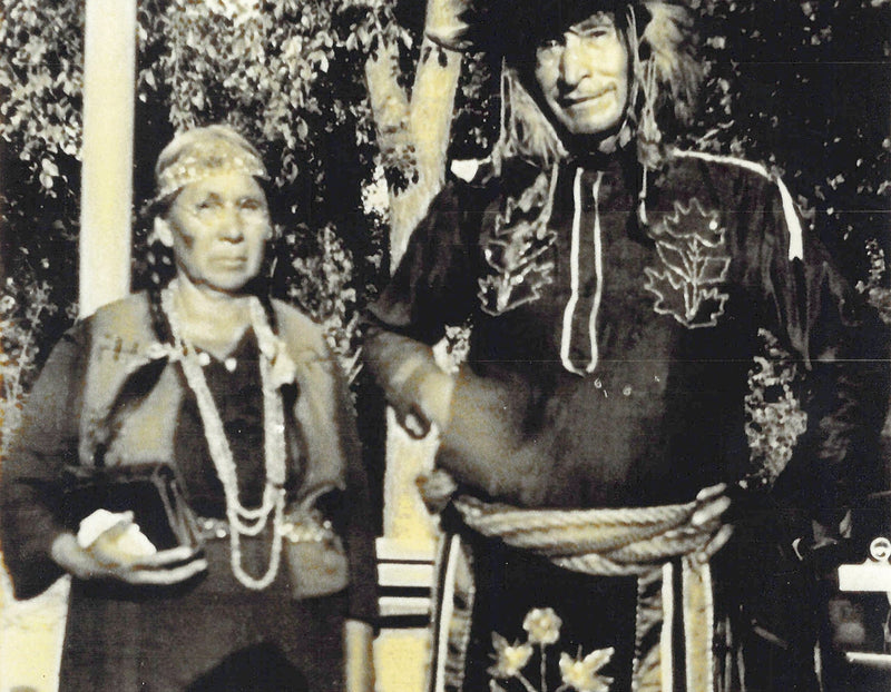 A black and white photo of the founders Native American relatives wearing their traditional attire.